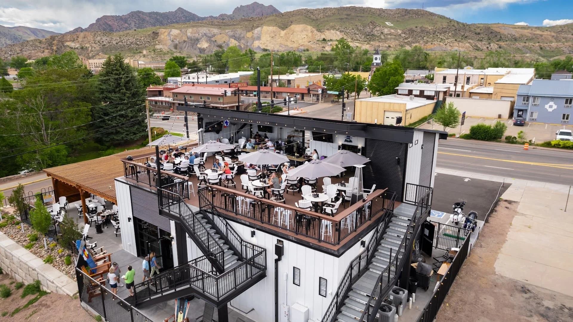 Aerial view of rooftop patio with mountain backdrop